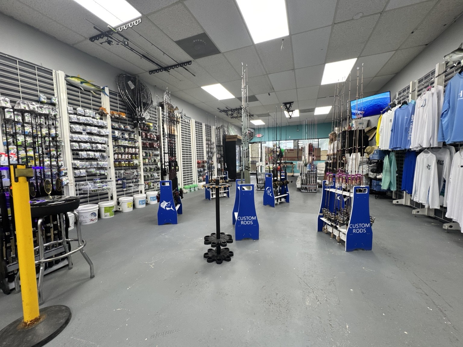Inside Spillway with fishing rods, tackle displays, and clothing